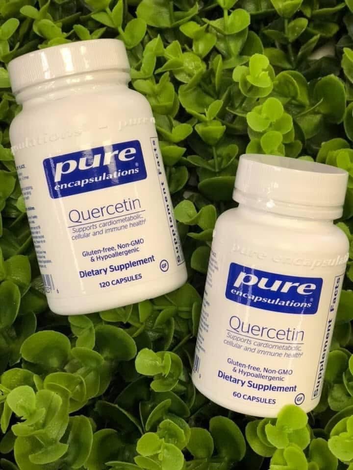 Pure Encapsulations Quercetin bottles among green leaves